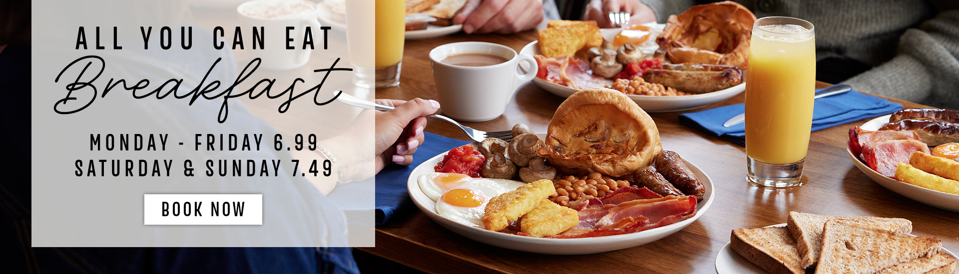 A promotional photograph of an All You Can Eat Breakfast at Toby Carvery, including sausages, hash browns, baked beans and fried egg.